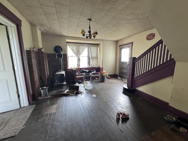 7915 N 4100 E Rd, Saybrook, IL 61770 - living room featuring a wood stove, wood-type flooring, a chandelier, and stairs
