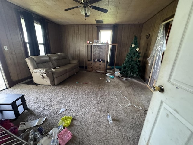 7915 N 4100 E Rd, Saybrook, IL 61770 - living room with ceiling fan, wood walls, and carpet flooring