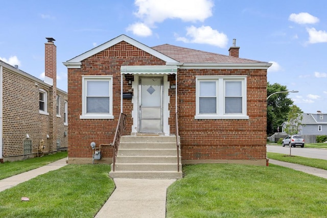 6000 S Mayfield Ave, Chicago, IL 60638 - bungalow featuring brick siding, a front yard, and a chimney