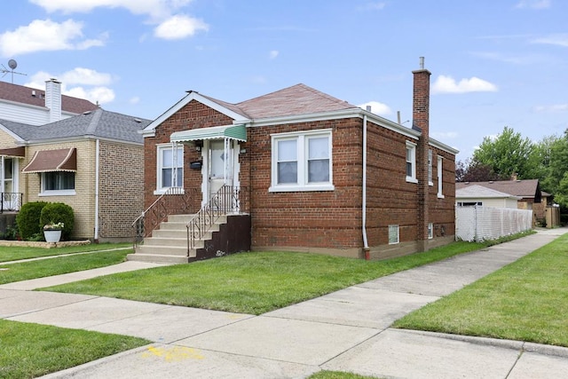 6000 S Mayfield Ave, Chicago, IL 60638 - bungalow-style house featuring a front lawn, brick siding, a chimney, and a shingled roof