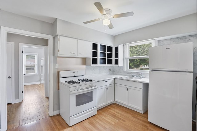 6000 S Mayfield Ave, Chicago, IL 60638 - kitchen with white appliances, light countertops, light wood-style floors, white cabinets, and a ceiling fan