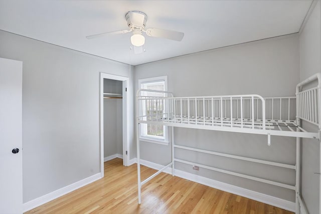6000 S Mayfield Ave, Chicago, IL 60638 - unfurnished bedroom with wood finished floors, ceiling fan, and a closet