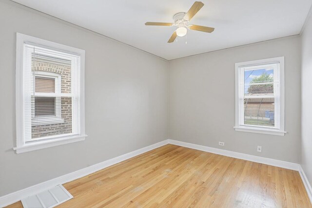 6000 S Mayfield Ave, Chicago, IL 60638 - spare room featuring light wood-style floors and ceiling fan