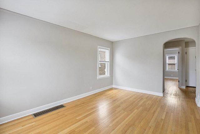 6000 S Mayfield Ave, Chicago, IL 60638 - empty room with arched walkways, healthy amount of natural light, and light wood-style flooring