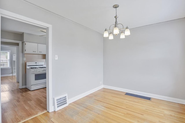 6000 S Mayfield Ave, Chicago, IL 60638 - empty room with a chandelier and light wood-style flooring