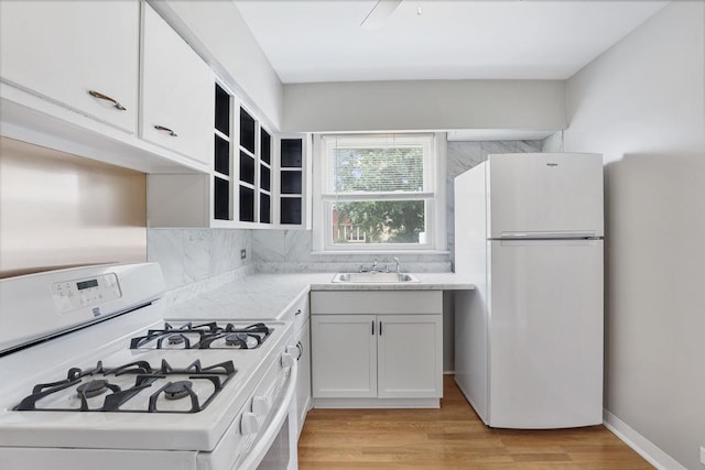6000 S Mayfield Ave, Chicago, IL 60638 - kitchen with white appliances, tasteful backsplash, light countertops, light wood-style flooring, and white cabinets