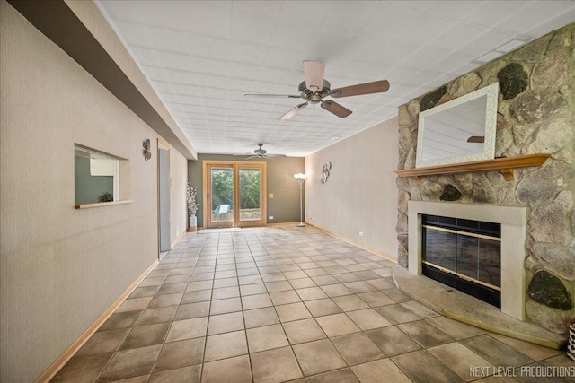 680 N Grace St, Lombard, IL 60148 - unfurnished living room featuring a stone fireplace, a ceiling fan, and tile patterned flooring