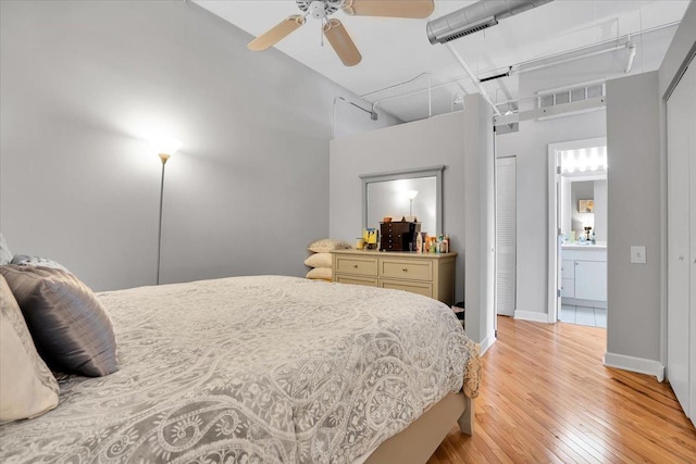 500 S Clinton St Unit 527, Chicago, IL 60607 - bedroom featuring light wood finished floors, connected bathroom, a high ceiling, and ceiling fan