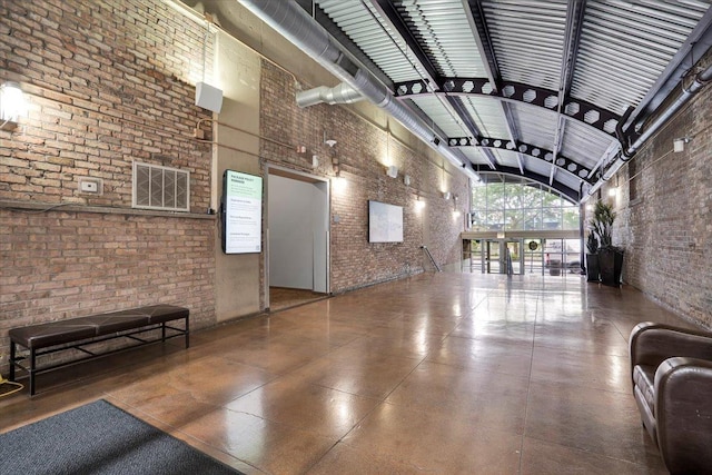 500 S Clinton St Unit 527, Chicago, IL 60607 - building lobby with brick wall, high vaulted ceiling, and beamed ceiling