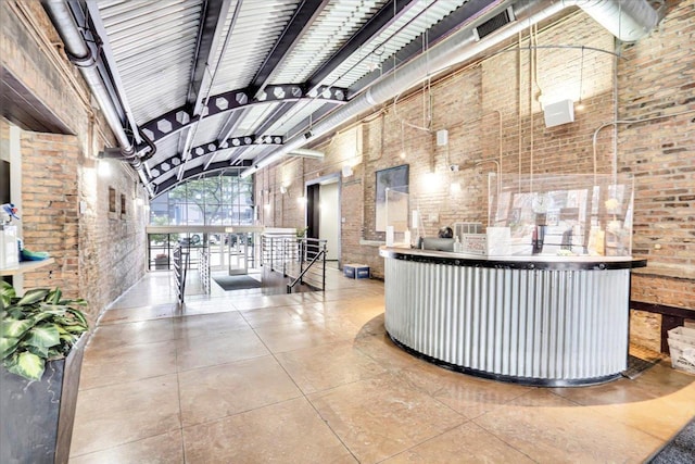 500 S Clinton St Unit 527, Chicago, IL 60607 - reception with brick wall, beam ceiling, and high vaulted ceiling