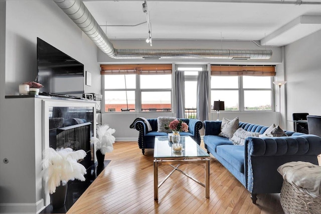 500 S Clinton St Unit 527, Chicago, IL 60607 - living room with hardwood / wood-style flooring, track lighting, and a fireplace with flush hearth