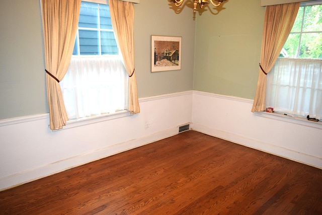 2008 Mcdaniel Ave, Evanston, IL 60201 - empty room with a chandelier and dark wood-style flooring