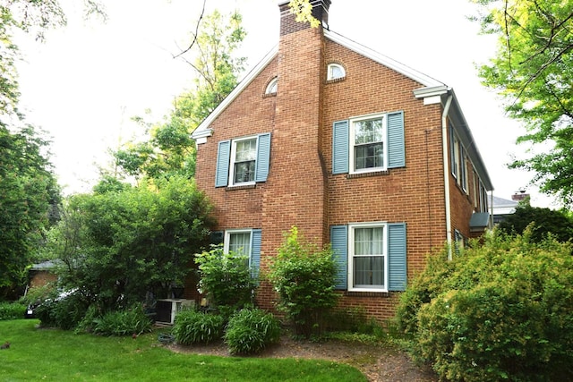 2008 Mcdaniel Ave, Evanston, IL 60201 - view of home's exterior featuring brick siding, a chimney, and a lawn