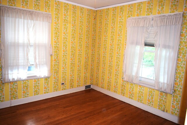 2008 Mcdaniel Ave, Evanston, IL 60201 - unfurnished room with dark wood-style flooring, ornamental molding, and wallpapered walls