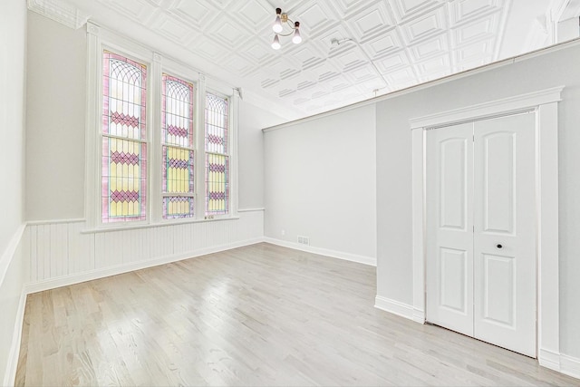 200 W Crawford St, Peotone, IL 60468 - unfurnished bedroom with multiple windows, wood finished floors, a closet, an ornate ceiling, and crown molding