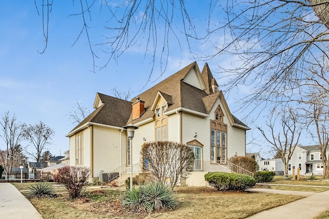 200 W Crawford St, Peotone, IL 60468 - view of side of home featuring a residential view, a chimney, and a shingled roof