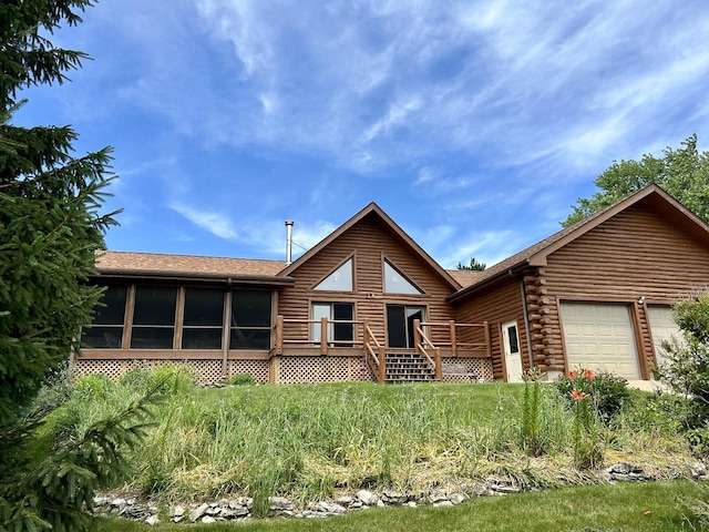 3468 E Spring Creek Dr, Ladd, IL 61329 - cabin featuring an attached garage, log exterior, a wooden deck, a sunroom, and roof with shingles