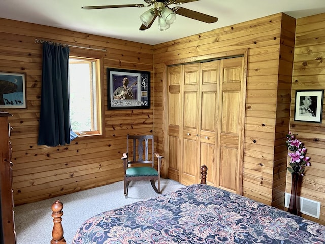 3468 E Spring Creek Dr, Ladd, IL 61329 - bedroom with wooden walls, carpet, a ceiling fan, and a closet