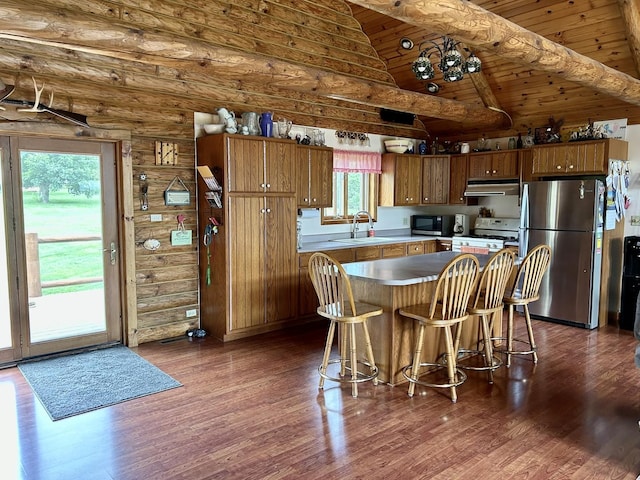 3468 E Spring Creek Dr, Ladd, IL 61329 - kitchen with freestanding refrigerator, black microwave, under cabinet range hood, white gas range, and dark wood-type flooring