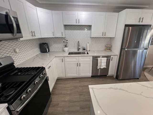 7125 Oconnell Dr Unit 102, Chicago Ridge, IL 60415 - kitchen featuring stainless steel appliances, white cabinets, wood finished floors, tasteful backsplash, and light stone countertops