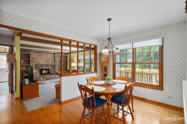 1453 Yale Ct, Naperville, IL 60565 - dining space with wallpapered walls, wood finished floors, a fireplace, and plenty of natural light