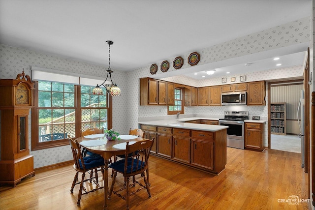 1453 Yale Ct, Naperville, IL 60565 - kitchen featuring wallpapered walls, stainless steel appliances, light wood-style flooring, brown cabinetry, and light countertops