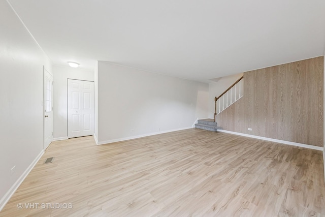 2733 Weeping Willow Dr Unit 26-C, Lisle, IL 60532 - unfurnished room with stairs, light wood finished floors, and wood walls