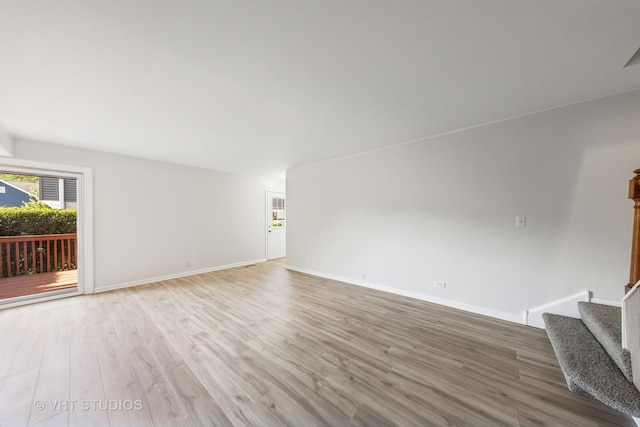 2733 Weeping Willow Dr Unit 26-C, Lisle, IL 60532 - unfurnished living room featuring light wood-style floors and stairs