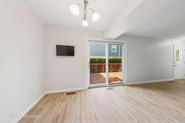 2733 Weeping Willow Dr Unit 26-C, Lisle, IL 60532 - empty room with a chandelier and light wood-type flooring