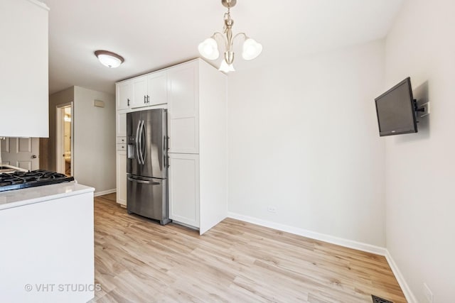 2733 Weeping Willow Dr Unit 26-C, Lisle, IL 60532 - kitchen with stainless steel fridge with ice dispenser, white cabinets, light wood-style floors, and decorative light fixtures