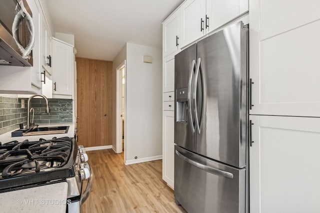 2733 Weeping Willow Dr Unit 26-C, Lisle, IL 60532 - kitchen featuring appliances with stainless steel finishes, light wood-type flooring, tasteful backsplash, and white cabinetry