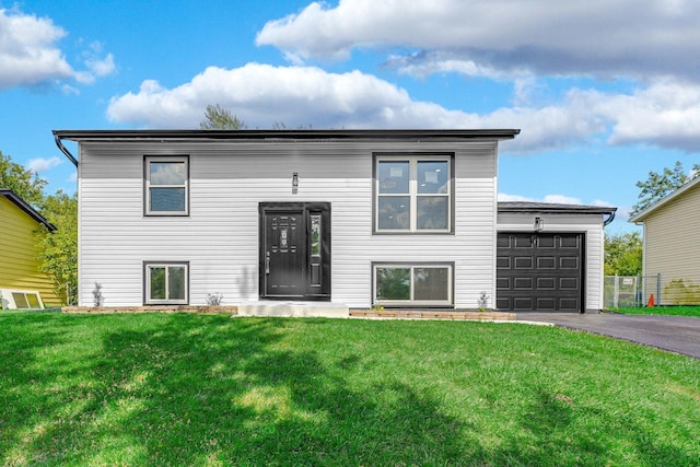 view of front of house with driveway, a garage, and a front lawn