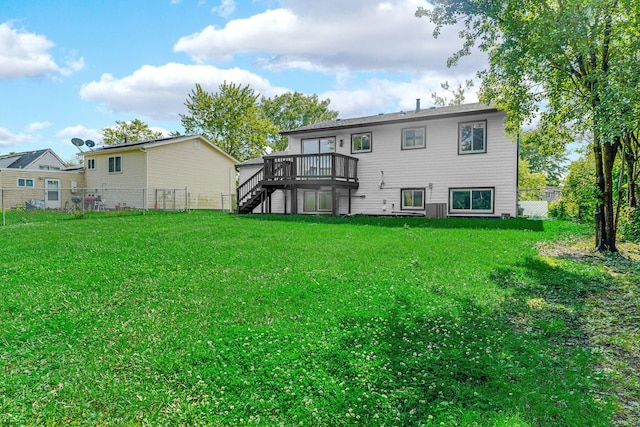 back of property featuring stairway, a wooden deck, and a fenced backyard