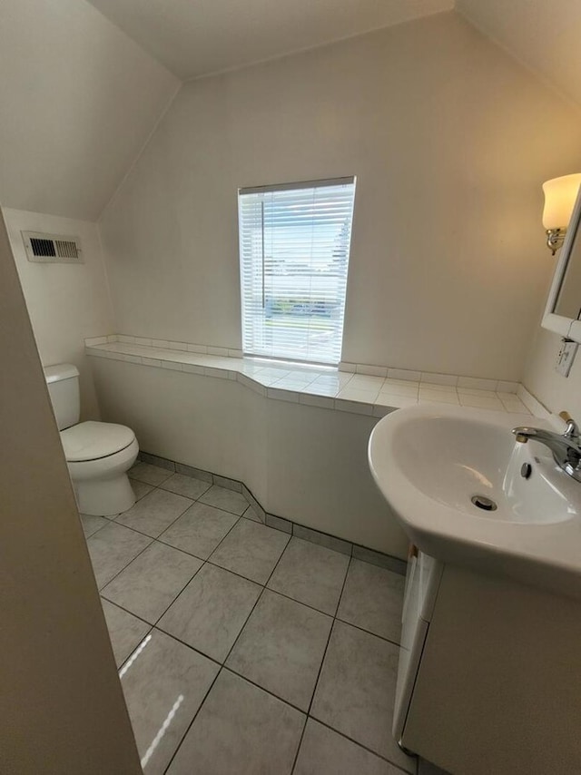 7155 W 71st St, Chicago, IL 60638 - bathroom with lofted ceiling, tile patterned floors, and vanity