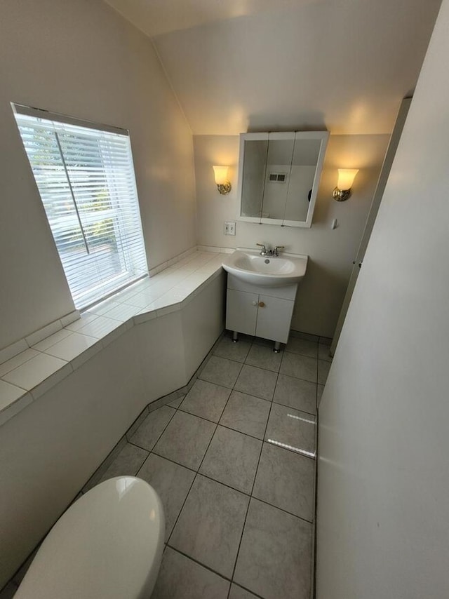 7155 W 71st St, Chicago, IL 60638 - bathroom with vanity, lofted ceiling, and tile patterned flooring