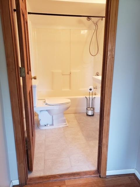 7155 W 71st St, Chicago, IL 60638 - bathroom featuring bathing tub / shower combination and tile patterned floors