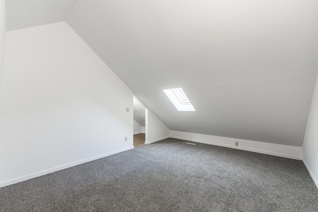 402 N St, Monroe Center, IL 61052 - bonus room featuring lofted ceiling, a skylight, and dark colored carpet