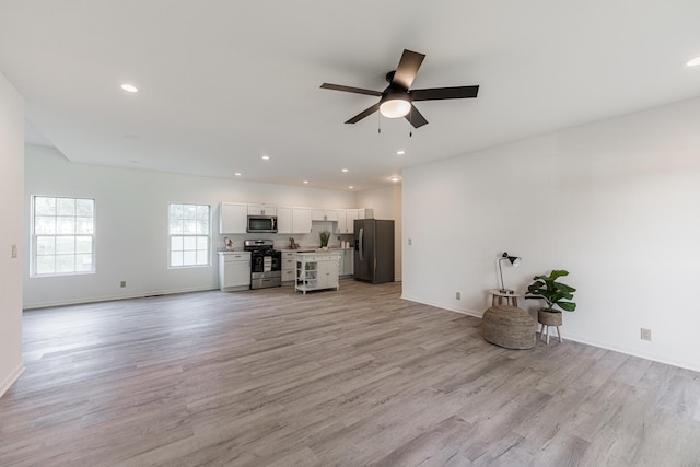 402 N St, Monroe Center, IL 61052 - unfurnished living room with a ceiling fan, light wood-style floors, and recessed lighting