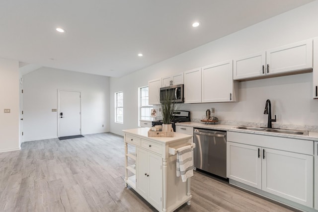 402 N St, Monroe Center, IL 61052 - kitchen featuring stainless steel appliances, light countertops, light wood-style floors, recessed lighting, and white cabinets