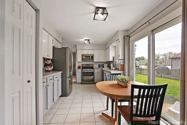 2184 N Masters Ln, Lake Villa, IL 60046 - kitchen featuring appliances with stainless steel finishes, healthy amount of natural light, light tile patterned flooring, and light countertops