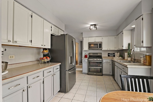 2184 N Masters Ln, Lake Villa, IL 60046 - kitchen featuring stainless steel appliances, light tile patterned floors, light countertops, and white cabinets