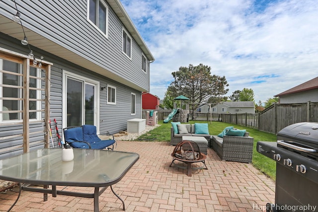 2184 N Masters Ln, Lake Villa, IL 60046 - fenced backyard with a grill, an outdoor living space with a fire pit, a playground, and a patio