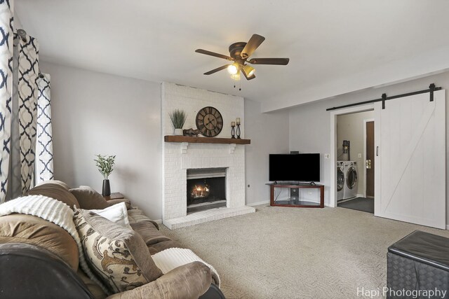 2184 N Masters Ln, Lake Villa, IL 60046 - carpeted living room with washer and clothes dryer, a ceiling fan, a barn door, and a fireplace