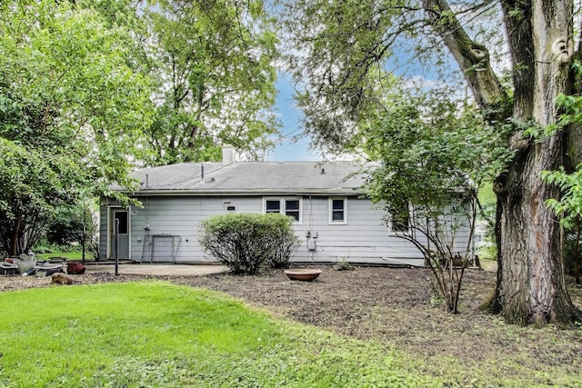2030 Cedar Ave, Hanover Park, IL 60133 - rear view of house featuring a yard, a patio area, and a chimney