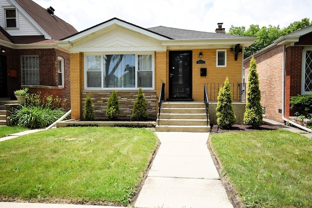 8812 S Euclid Ave, Chicago, IL 60617 - view of front of house featuring a chimney and a front yard