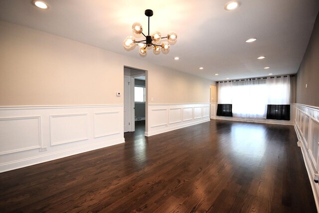 8812 S Euclid Ave, Chicago, IL 60617 - unfurnished living room with a chandelier, recessed lighting, a wainscoted wall, a decorative wall, and dark wood-style floors