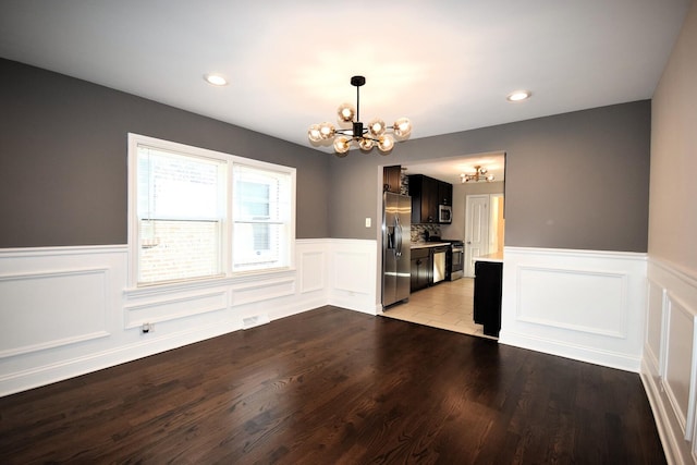 8812 S Euclid Ave, Chicago, IL 60617 - unfurnished dining area featuring a chandelier, a wainscoted wall, a decorative wall, light wood-type flooring, and recessed lighting
