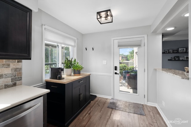1258 Chalet Rd Unit 104, Naperville, IL 60563 - kitchen with dark cabinetry, dishwasher, healthy amount of natural light, wood finished floors, and recessed lighting