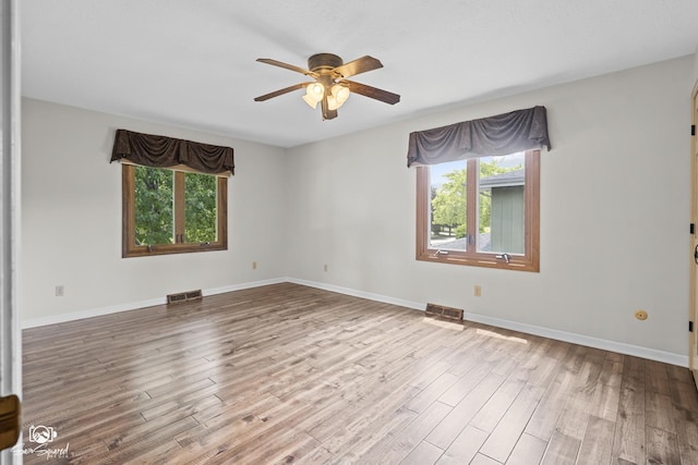 509 Apollo Dr, Joliet, IL 60435 - empty room featuring healthy amount of natural light, ceiling fan, and wood finished floors