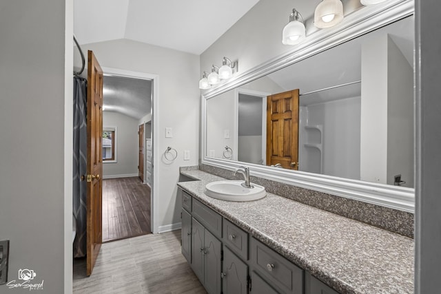 509 Apollo Dr, Joliet, IL 60435 - full bathroom featuring vaulted ceiling, vanity, and wood finished floors